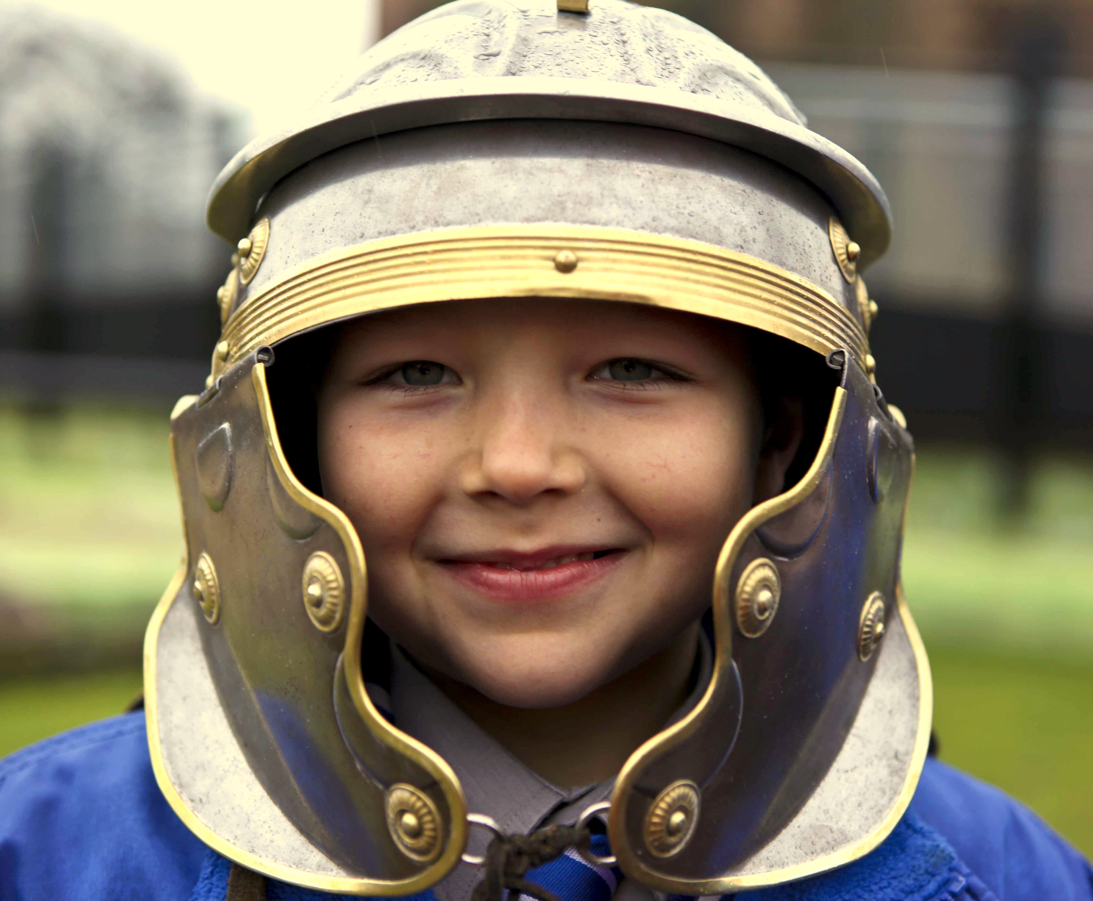 A portrait of a young child wearing a helmet