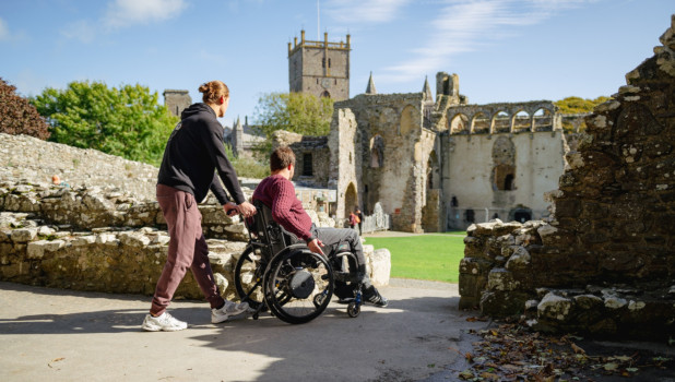 Two friends, one in a wheelchair visiting St Davids grounds