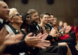 Spectators clapping in the theatre, close up of hands