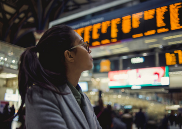 A woman checking the train timetable