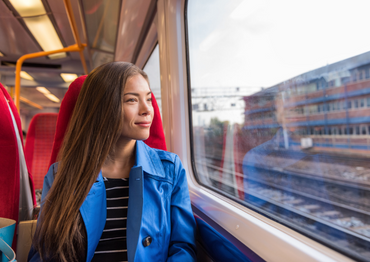 Train woman leaving for work in morning commute commuting to city. 
